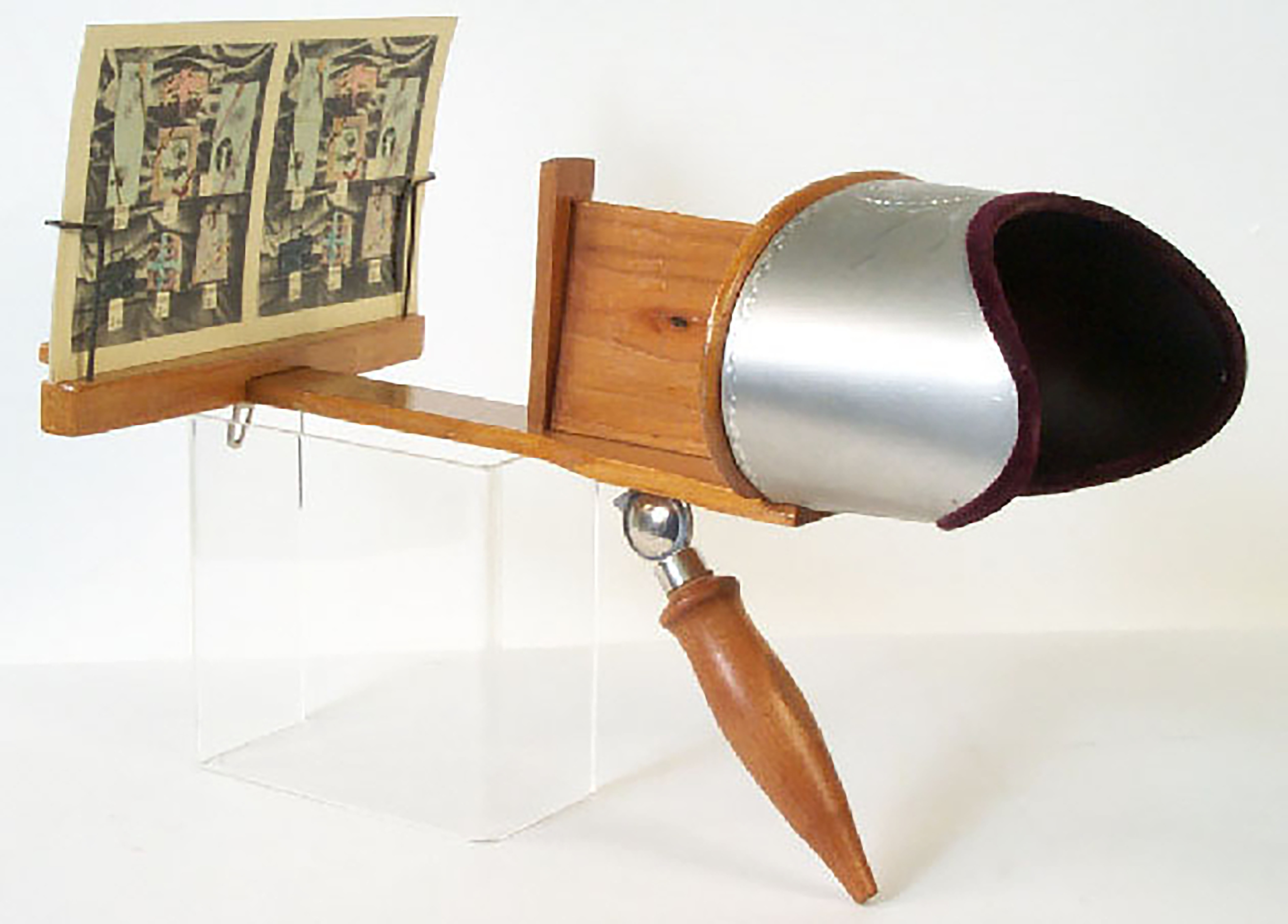 Traditional stereoscope viewer holding a stereograph card.